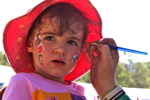 Young girl getting her face painted