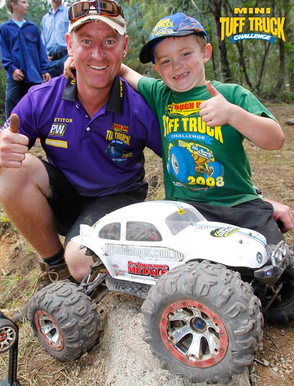 Man and boy posing with RC buggy
